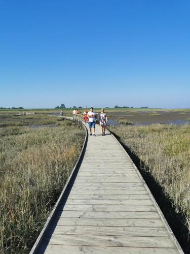 a group of people walking on a boardwalk at AAR Nordsee Appartement in Varel