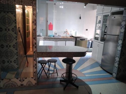 - une cuisine avec un comptoir et des tabourets dans l'établissement Maison brahim, à Agadir