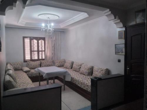 - un salon avec un canapé et une table dans l'établissement Maison brahim, à Agadir