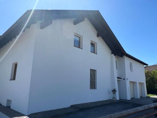 a white building with a black roof at Cityapartments Reutte in Reutte