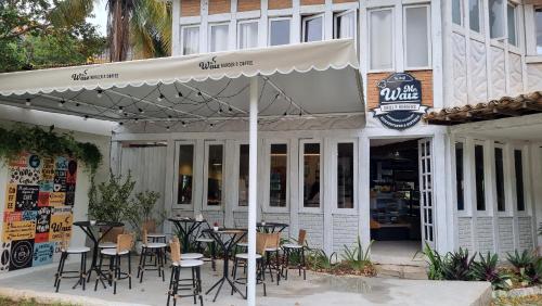 a restaurant with tables and chairs under an umbrella at Pousada New Paradise in Búzios