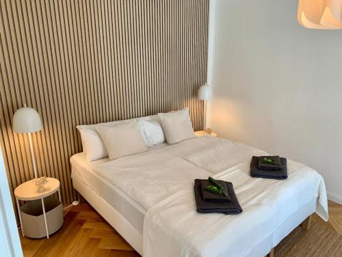 a bedroom with a white bed with two towels on it at Stilvoll wohnen am St. Johanner Markt in Saarbrücken
