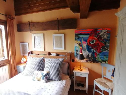 a bedroom with a bed and a painting on the wall at Les Pedres in Camprodon