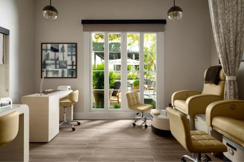 a salon with a waiting room with chairs and a window at Plaza San Antonio Hotel & Spa, Autograph Collection in San Antonio