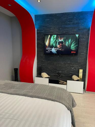 a bedroom with a bed and a flat screen tv at Apartment Deluxe Livno in Livno