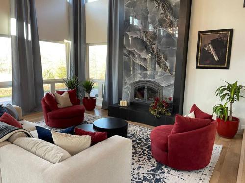 a living room with two couches and a fireplace at La joie de vivre in South Haven