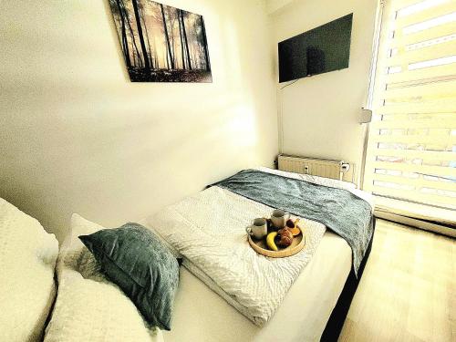 a room with a bed with a tray of food on it at Am Feldrain in Hannoversch Münden
