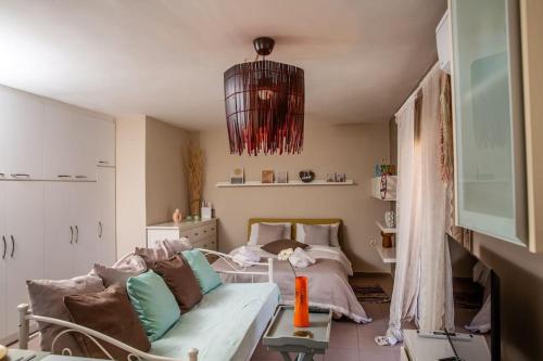 a living room with a couch and a bed at Downtown Lavrio Port Cozy Apt in Lávrion