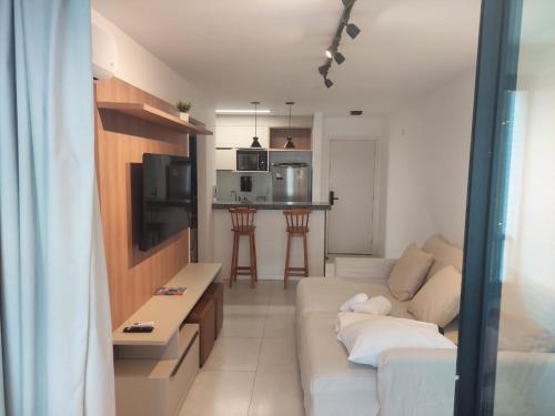 Televízia a/alebo spoločenská miestnosť v ubytovaní Apartamento Novo em Ondina