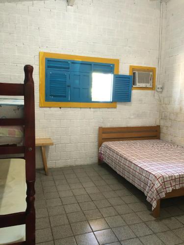 a room with two beds and a window at Paraíso na Barra de Mamanguape Beira do Rio in Rio Tinto