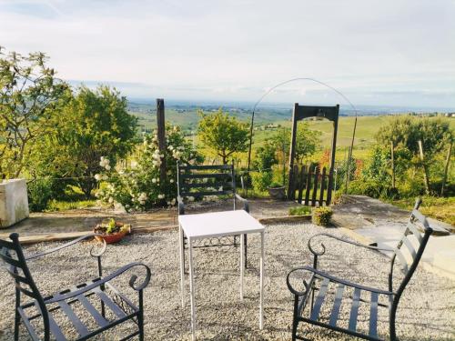 a table and two chairs in a garden with a view at NiFe Tiny House - Secret Garden in Montalbo