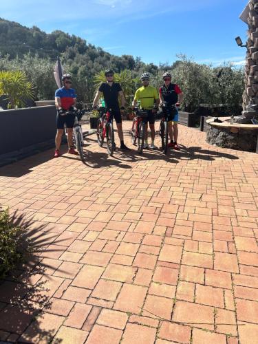 a group of people riding bikes on a brick path at la Tana di Luna in Adrano