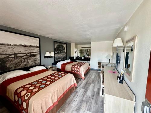 a hotel room with two beds and a television at Super 8 by Wyndham Athens TX in Athens