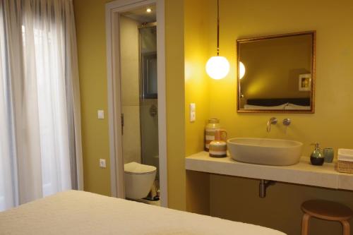 a bathroom with a sink and a mirror at Absolute Athens Acropolis View in Athens