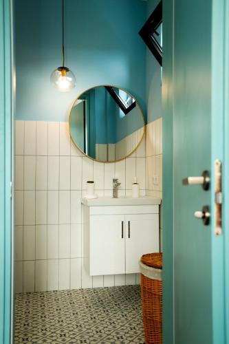 a bathroom with a sink and a mirror at Villa Capri-Kaprovani in Shekvetili
