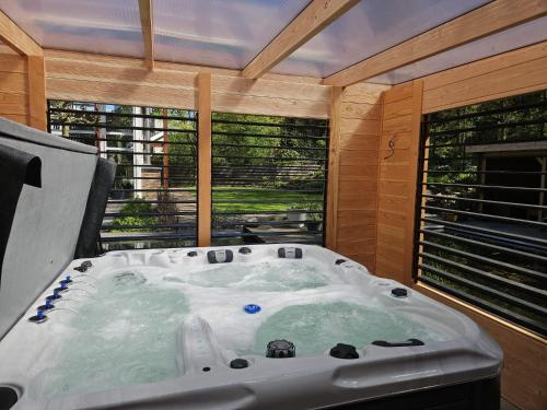 a bath tub in a room with a window at Artz of Nature in Emmen