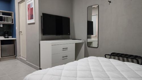 a bedroom with a bed and a television on a dresser at WUER Expiatorio in León