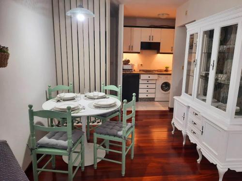 a dining room with a table and chairs and a kitchen at Apartamento En Camino - Milladoiro in Milladoiro