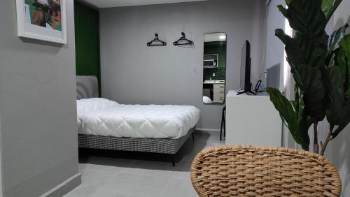 a bedroom with a bed and a mirror and a chair at WUER Expiatorio in León