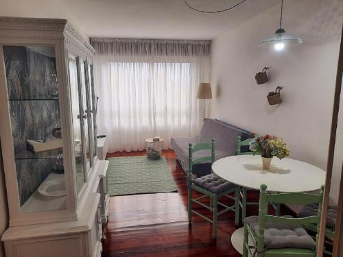 a living room with a table and a couch at Apartamento En Camino - Milladoiro in Milladoiro