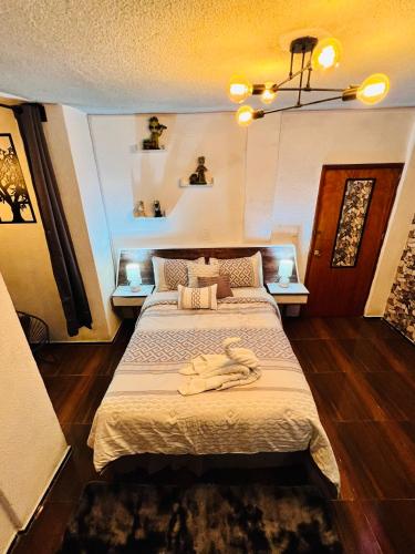 a bedroom with a large bed with a robe on it at Habitación Diamante in Orizaba