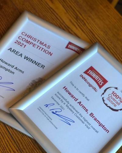 two tickets to a skiing destination on a table at The Howard Arms in Brampton
