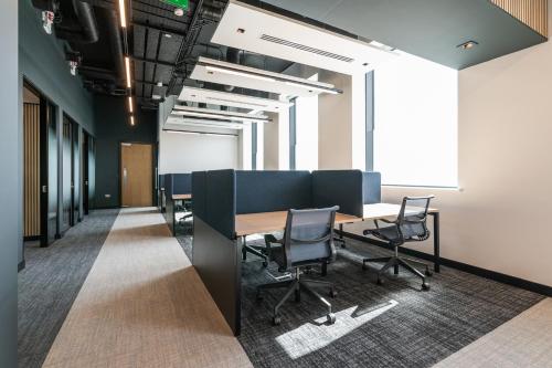 an office with a conference room with a table and chairs at The Cornerstone Two by Dublin At Home in Dublin