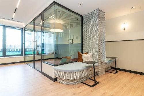 a glass room with a chair and a table at The Cornerstone Two by Dublin At Home in Dublin