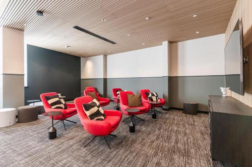 a waiting room with red chairs and a podium at The Cornerstone Two by Dublin At Home in Dublin