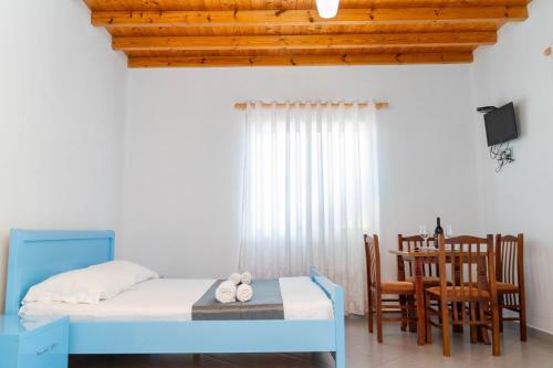 a bedroom with a bed and a table and chairs at Vila Anxhelo in Vlorë