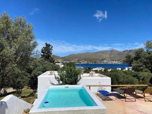 a swimming pool on a patio with a view of the water at The Velanidies - Οι Βελανιδιές in Agia Marina