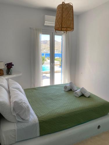 a bedroom with a large bed with towels on it at The Velanidies - Οι Βελανιδιές in Agia Marina