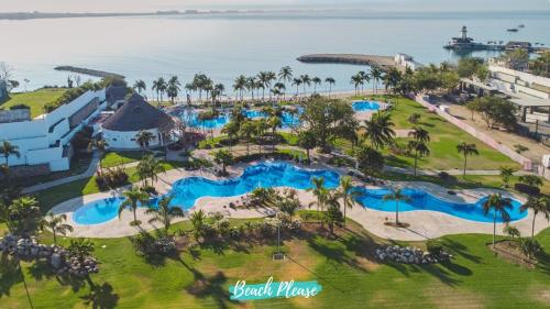 an aerial view of the pool at the beach house resort at Tamaran Family Villas with Beach Club - B Nayar in Cruz de Huanacaxtle