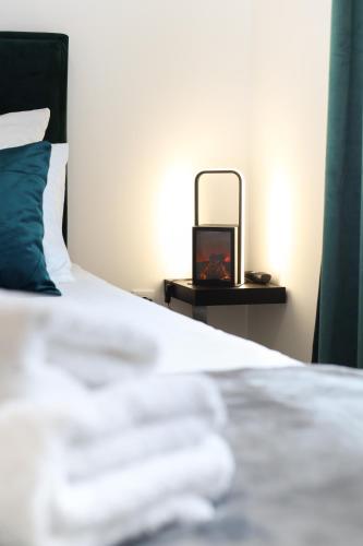 a bed with a side table with a mirror on it at Airport Belgrade Apartments in Surčin