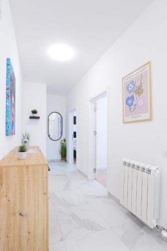 a white room with a hallway with a radiator at Airport Belgrade Apartments in Surčin