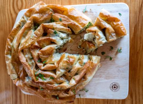 a pie on a cutting board on a table at Welbeck Hotel & Apartments IOM in Douglas
