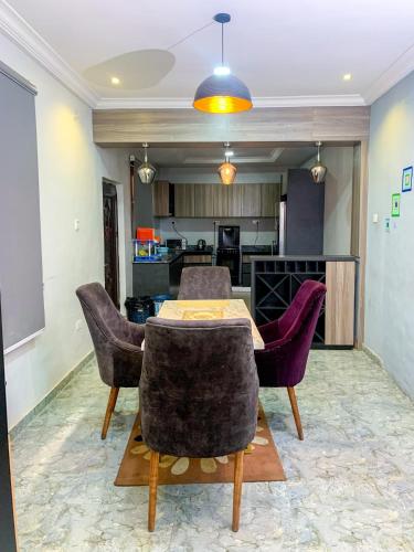 a dining room with a table and some chairs at 28B (3/2B) in Lagos
