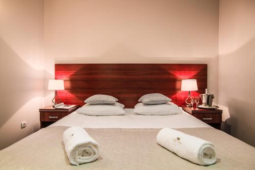 a bedroom with a bed with two towels on it at Hotel Polonia in Biała Podlaska
