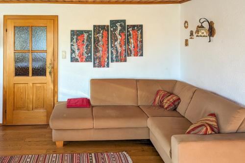 a living room with a brown couch and a door at Private Farmhouse Escape - Ideal for up to 8 Guests in Seeham