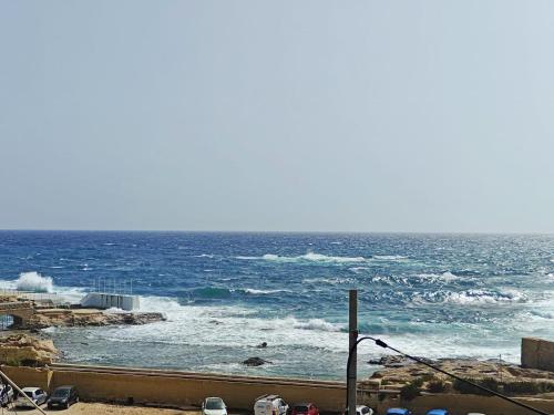a view of the ocean with waves in the water at Seabreeze Serenity Dragonara Horizon Residence in Paceville
