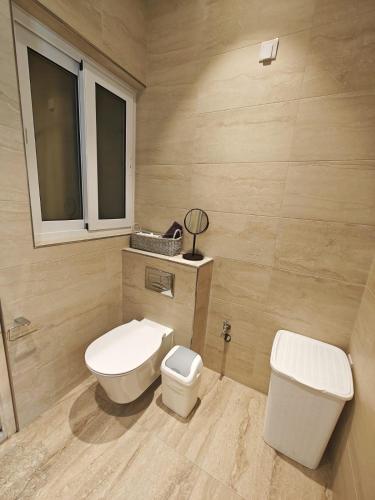 a bathroom with a toilet and a sink at Seabreeze Serenity Dragonara Horizon Residence in Paceville
