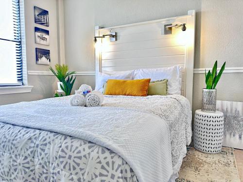 a bedroom with a bed with a white bedspread at Charming Jax Apt for 4 with free parking in Jacksonville