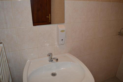 a bathroom with a sink and a mirror at Davi Penzion & Bowling in Rožňava