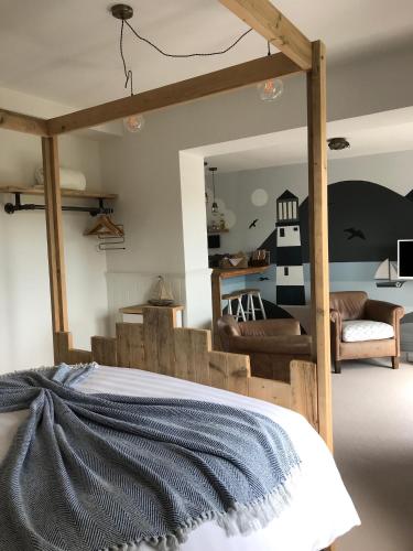 a bedroom with a bed with a wooden frame at Mevagissey Boutique Flatlet with sea and countryside views in Mevagissey