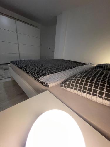 two twin beds in a room with avisor at Apartman Kis in Jajce