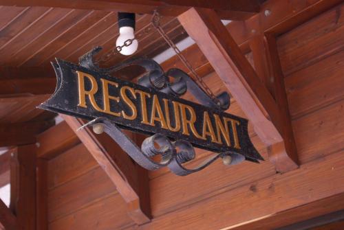 a sign that reads restaurant hanging from a ceiling at Flair Hotel Dobrachtal in Kulmbach