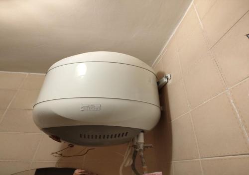 a toilet tank in the corner of a bathroom at Blumar Sidi Abdel Rahman 2 bedrooms Chalet North Coast in El Alamein