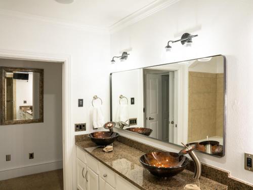 a bathroom with two sinks and a large mirror at Gallery Guest in Fayetteville