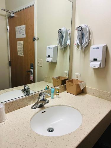 a bathroom counter with a sink and a mirror at HAWARDEN HARVEST INN in Hawarden