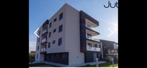 a large white building with a lot of windows at Ajkovic Residance in Vranići